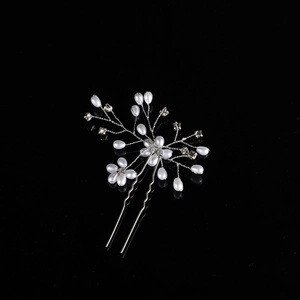 Detailed close-up of handmade bridal hair pin with pearls and crystal floral branch design