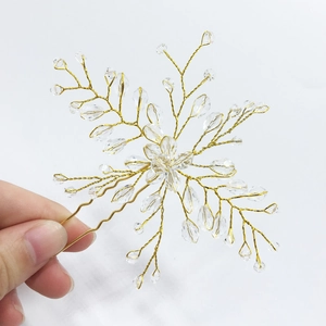 Detailed macro view of bridal crystal flower hair pin with gold wire weaving and clear beads
