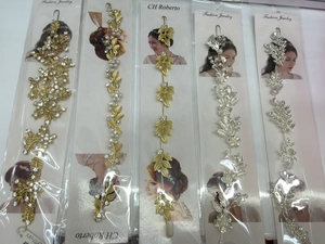Detailed view of assorted gold and silver bridal headbands with leaf and pearl accents