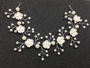 Detail of bridal hair vine with white clay roses, pearls, and silver wire flexible design