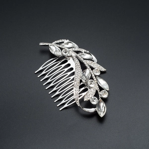Detail of silver leaf hair comb with sparkling marquise rhinestones on black background