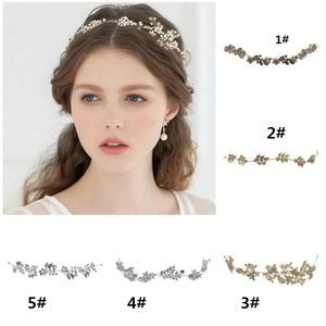Close-up of bridal headband set with rhinestones, pearls, and leaf designs for weddings