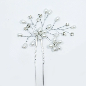 Macro detail of bridal hair pin with pearls and crystals on silver wire structure