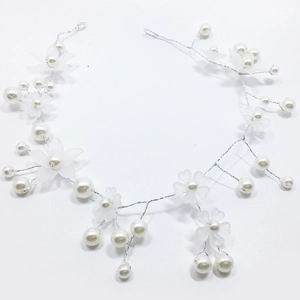 Detail of bridal hair vine with matte flowers and pearls on silver flexible wire