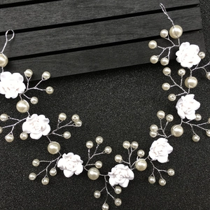 Detail of silver bridal hair vine with white clay roses and delicate faux pearls
