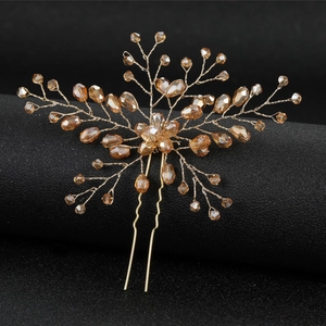 Macro detail of handmade bridal hair pin with champagne crystals and golden wire branches