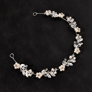 Detail of silver wedding headband with handmade pearls and sparkling rhinestones