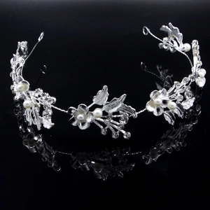 Macro detail of silver bridal headband featuring rhinestones, leaves and faux pearls