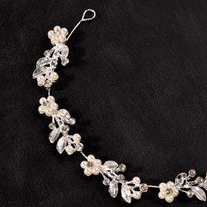 Detail of silver bridal headband with pearls, rhinestones and delicate leaf accents