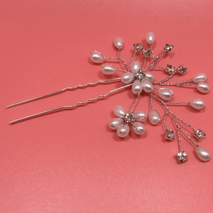 Detail of bridal hair pin with pearls and crystals on silver wire for wedding hairstyles