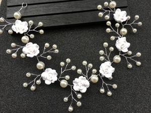 Detailed view of handmade bridal hairband with resin roses, pearls and silver wire