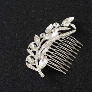 Close-up of bridal hair comb with marquise rhinestones and silver leaf details