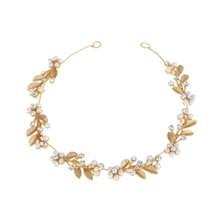 Golden bridal headband featuring white pearls, crystal rhinestones, and delicate leaf design