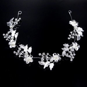 Close-up of bridal headband with silver alloy leaves, pearls and sparkling rhinestones