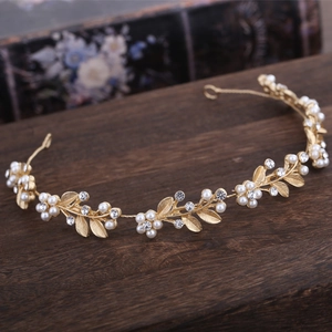 Golden bridal headband featuring elegant pearl flower design and sparkling rhinestones