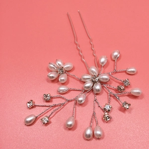 Detail of handmade bridal hair pin with pearls, crystals and silver wire flowers