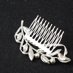Detailed back view of silver bridal hair comb showing leaf design and welding craft