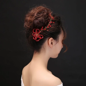 Detail of red handmade pearl flower headband for bridal hair styling in weddings
