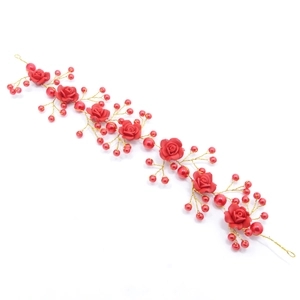 Detailed view of handmade bridal headband with red clay roses and pearls on gold wire