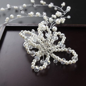 Macro shot of handmade bridal headband with white pearls, crystals and rhinestones