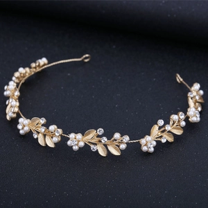 Elegant bridal gold headband with pearl flowers and crystal leaves on black background