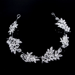 Close-up of silver bridal hair vine featuring crystal leaves and teardrop rhinestones