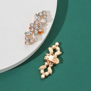Detail of sparkling rhinestone shoe buckles with gold alloy base and clip attachment
