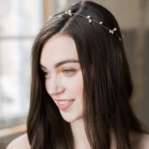 Handmade bridal headband with white pearls and gold wire vine on hair