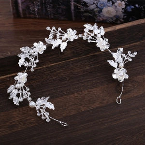 Elegant silver bridal headband with crystal flowers and pearl leaves for wedding hairstyle