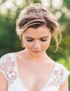 Detail of a handmade bridal hair vine with delicate pearls and soft wire on a model