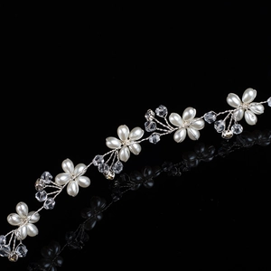 Silver bridal headband featuring handcrafted faux pearls and sparkling crystal flowers