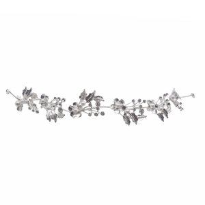 Detail of silver bridal hairband with crystal flowers, white pearls and hollow leaves