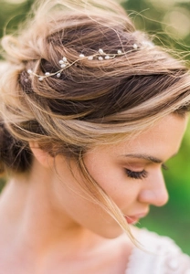 Close-up of handmade bridal hair vine with white pearls and gold wire in bohemian style