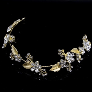 Detail shot of golden floral hair vine with crystal rhinestones and delicate leaf accents