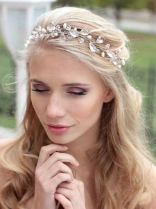 Detail of bridal headband with white pearls and crystal water drops on blonde model
