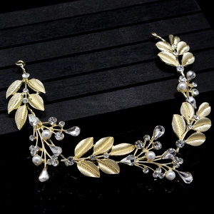 Detailed close-up of golden leaf bridal headpiece with white pearls and sparkling crystals