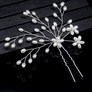 Elegant bridal silver hair pin with white pearls in flower shape on black background