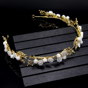 Close-up of golden floral bridal headband with white 3D flowers and sparkling rhinestones