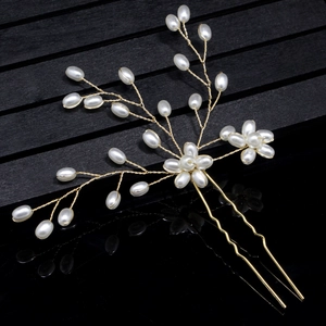 Elegant gold wire bridal hair pin set with white pearls in a delicate floral design