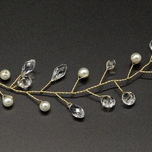 Macro detail of bridal hair vine with white pearls and sparkling crystal teardrops
