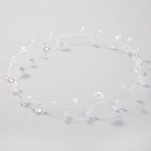 Detailed macro view of white pearls and crystal beads on a delicate silver bridal hair band
