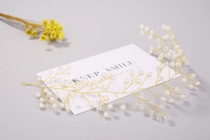 Vue détaillée d'un bijou de tête pour mariée avec perles blanches et cristaux dorés