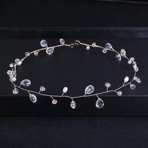 Elegant bridal headband featuring golden wire, crystal droplets, and white pearls