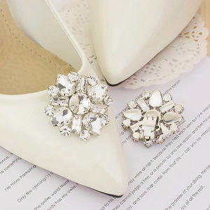 Detail of crystal bridal shoe clips with sparkling sunflower design and metal buckle