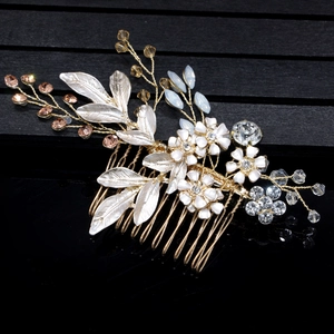 Detail of bridal hair comb with gold teeth, enamel flowers, and sparkling rhinestones
