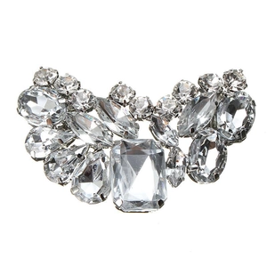 Macro shot of silver bridal shoe clips with crystal emerald and marquise stones