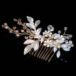 Detail of bridal hair comb with gold wire, white flowers, and crystal beads for weddings
