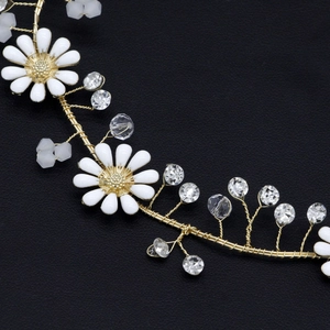 Detail of bridal headband featuring white daisy charms and sparkling crystal beads