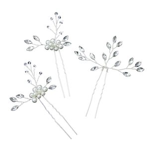 Detailed close-up of handmade bridal hair pins with white pearls and leaf crystals