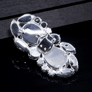 Detailed back view of a silver crystal shoe clip featuring a secure metal clasp mechanism
